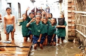 水につかりながら勉強を続ける子どもたち（バングラデシュ・ダッカ市内）写真＝JIFH＝